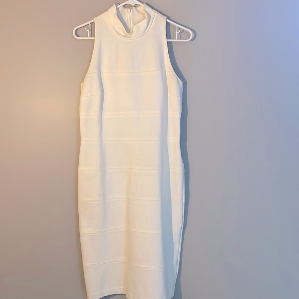 Size 8 creamy white dress hangs just below the knees. White House Black Market
